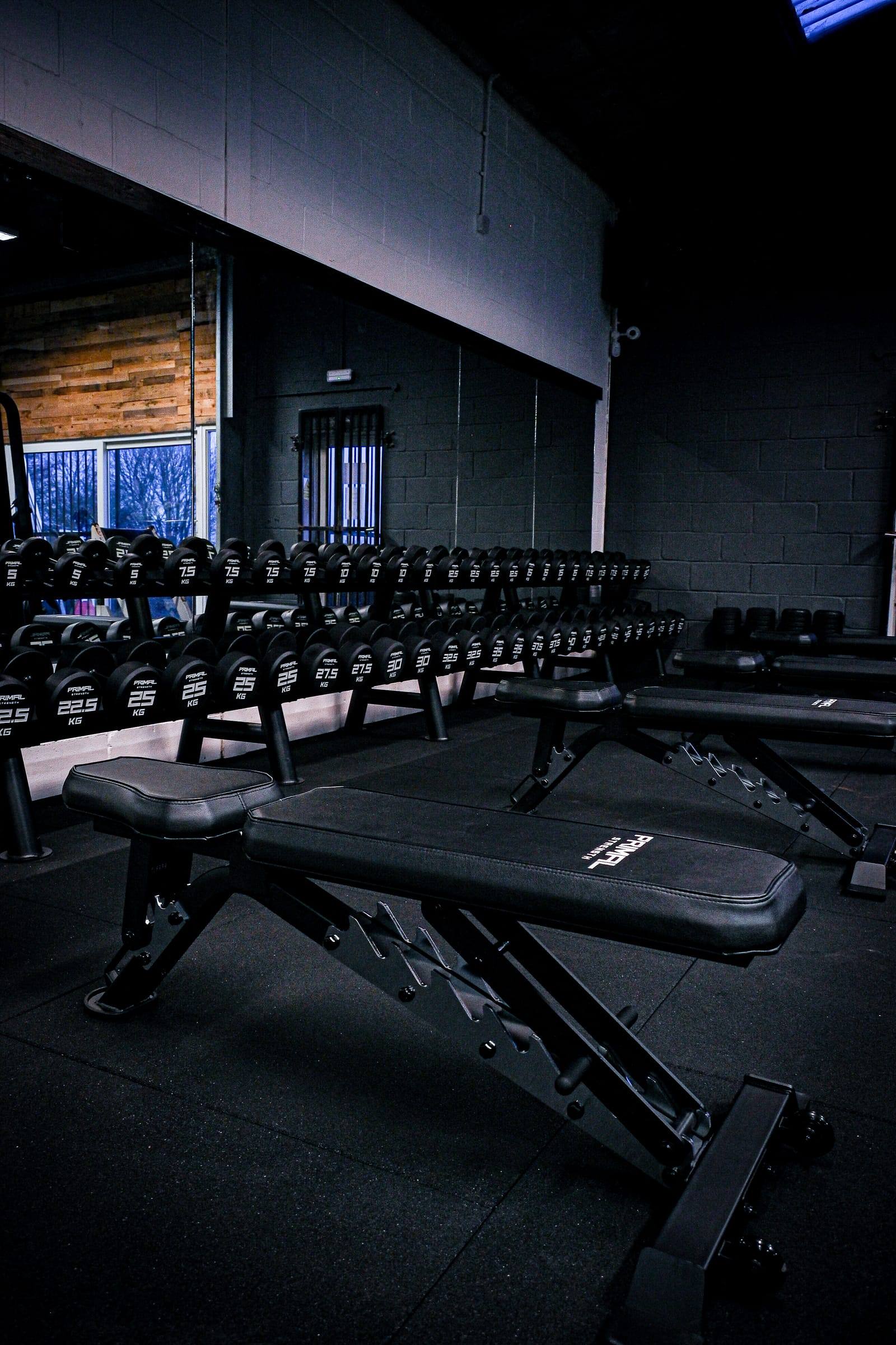 Bench and dumbbells beside the mirrors at Yeovil