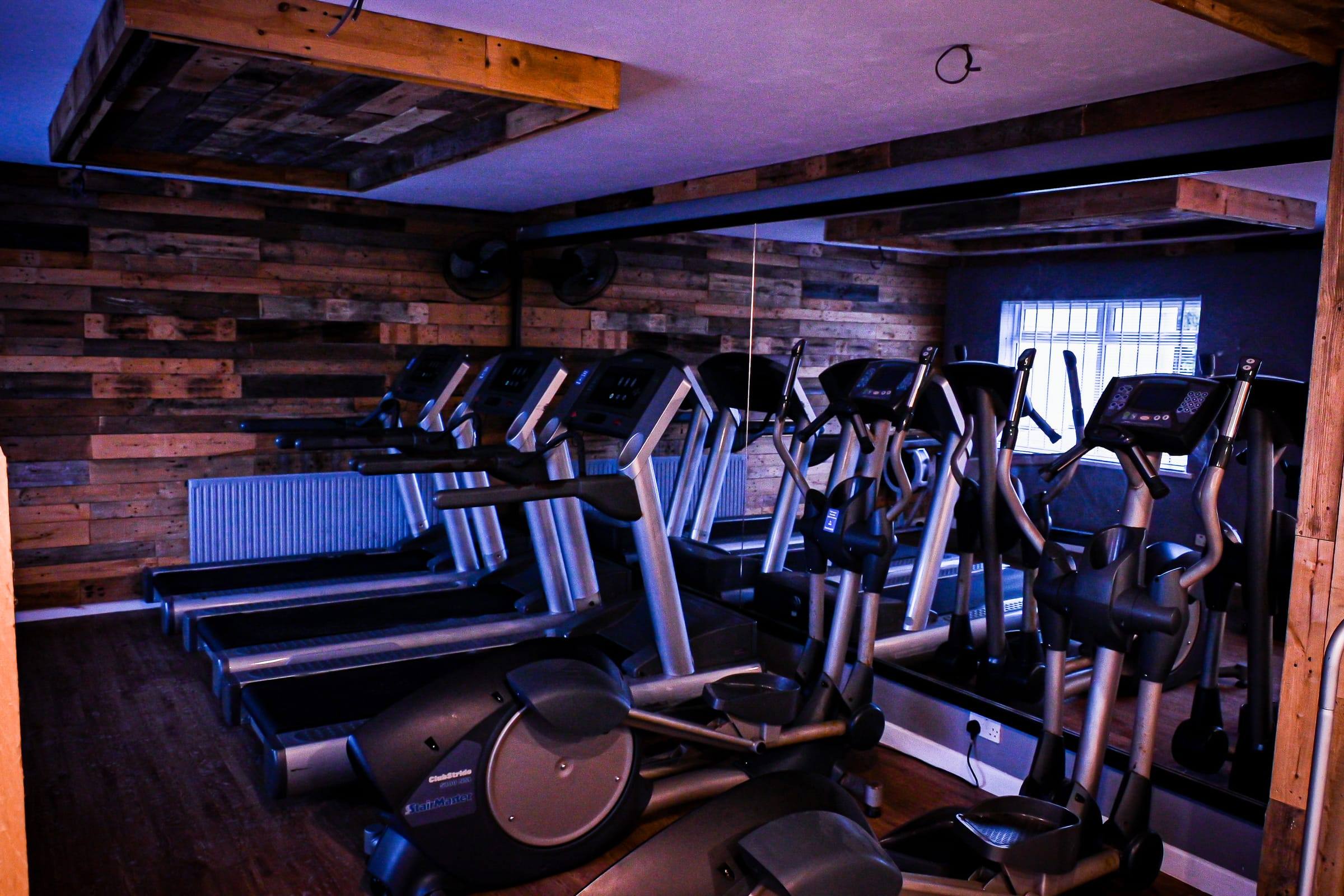 Cross-trainers and treadmills in the timber-clad Yeovil cardio room